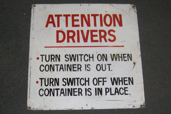 Sign-Attention drivers turn switch on when container is out... metal, stock number S-0114