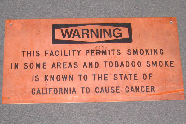 Sign-Warning this facility permits smoking in some areas, stock number S-0147