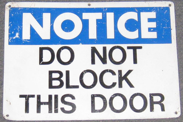 Sign-Notice Do Not Block This Door, stock number S-0248