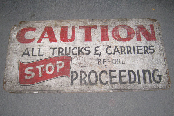 Sign-Caution all trucks and carriers stop before proceeding, stock number S-0301