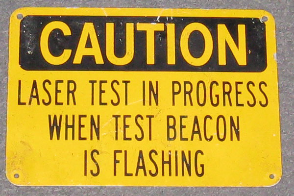 Sign-Caution Laser Test In Progress When Test Beacon Is Flashing, stock number S-0708