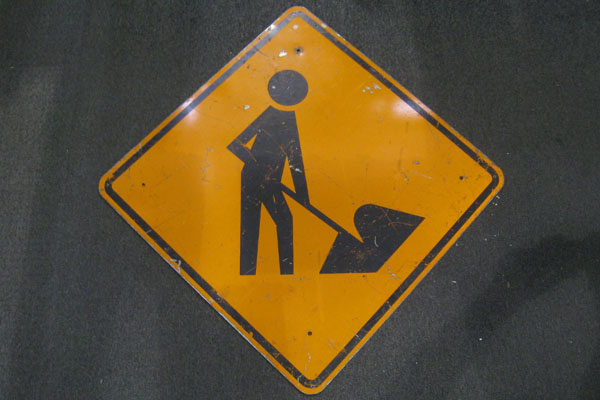 Sign-symbol of man working, stock number S-1059