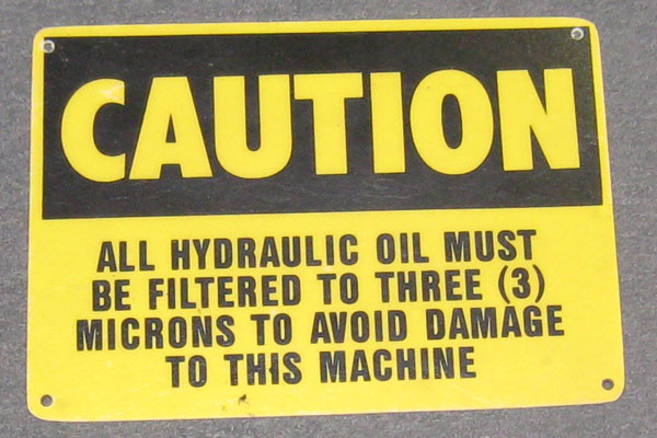 Sign-Caution - All hydraulic oil must be filtered to 3 microns to avoid damage, stock number S-1212