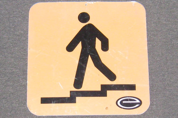 Sign-symbol of man walking downstairs, stock number S-1243