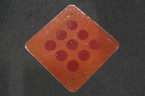 Sign-all red with 9 reflective circles, stock number S-2055