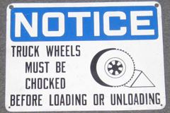 Sign-Notice truck wheels must be chocked before loading or unloading, stock number S-0019