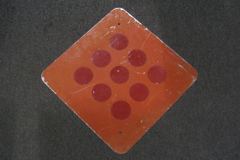 Sign-all red with 9 reflective circles, stock number S-2055